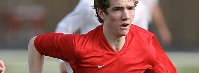 A young boy playing soccer.